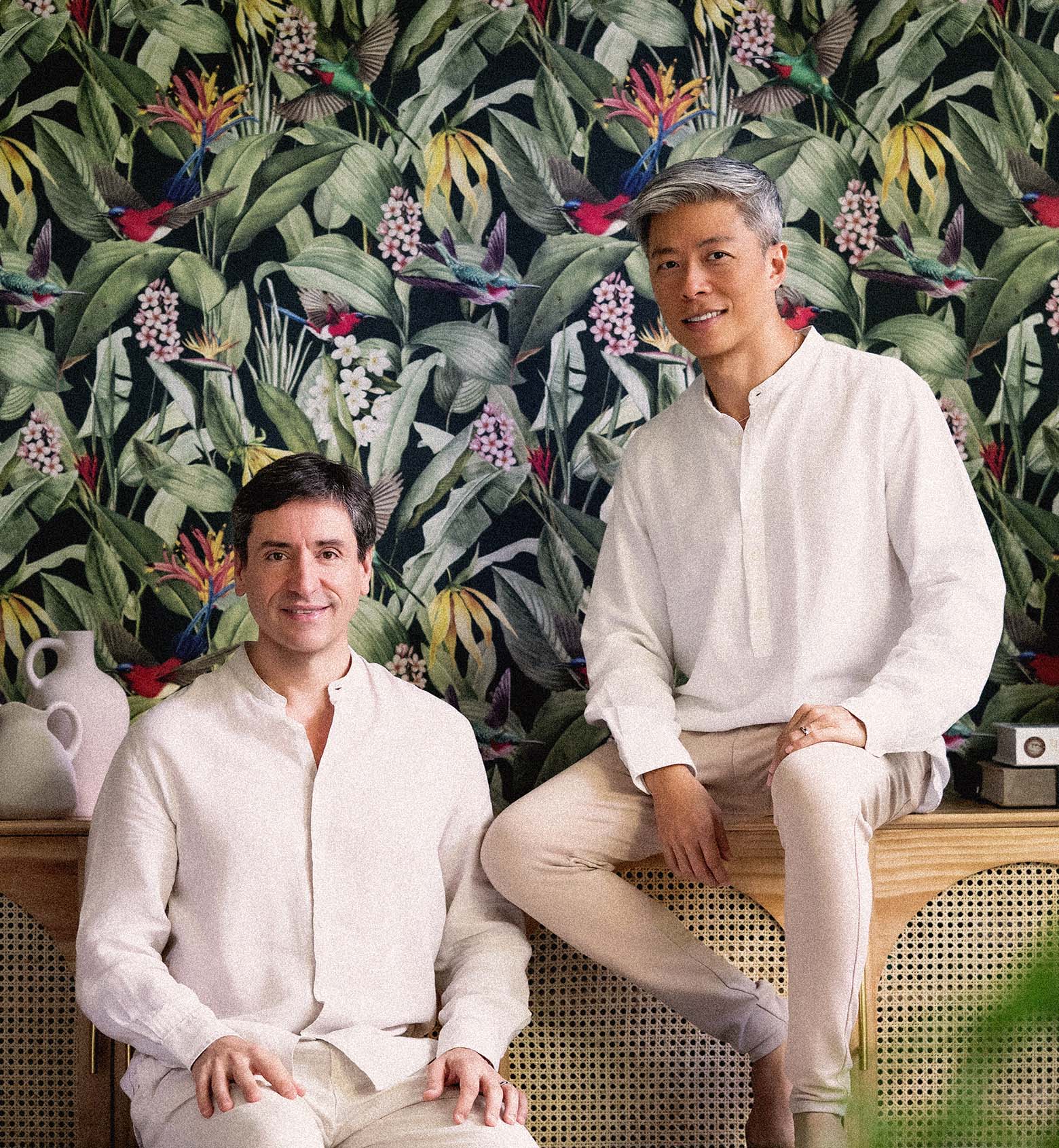 Belantara Founders, Shawn and Iker, sitting in front of the iconic Belantara tropical pattern.