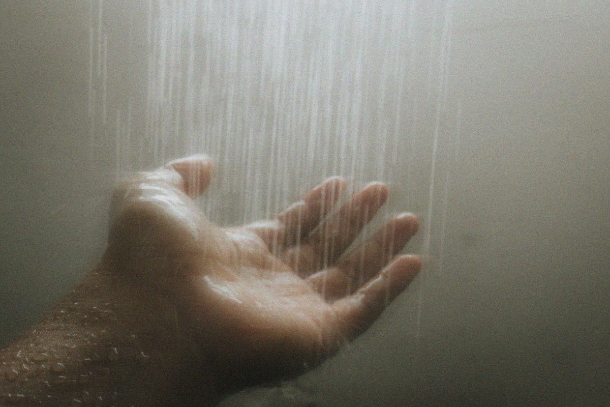 Hand under a hot shower