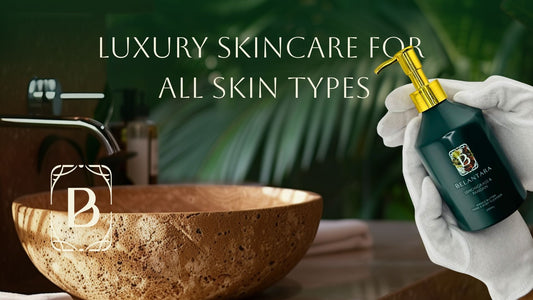 A marble vanity in a luxury bathroom with tropical plants. A bottle of Belantara Hand & Body Wash is held by a person wearing white gloves.