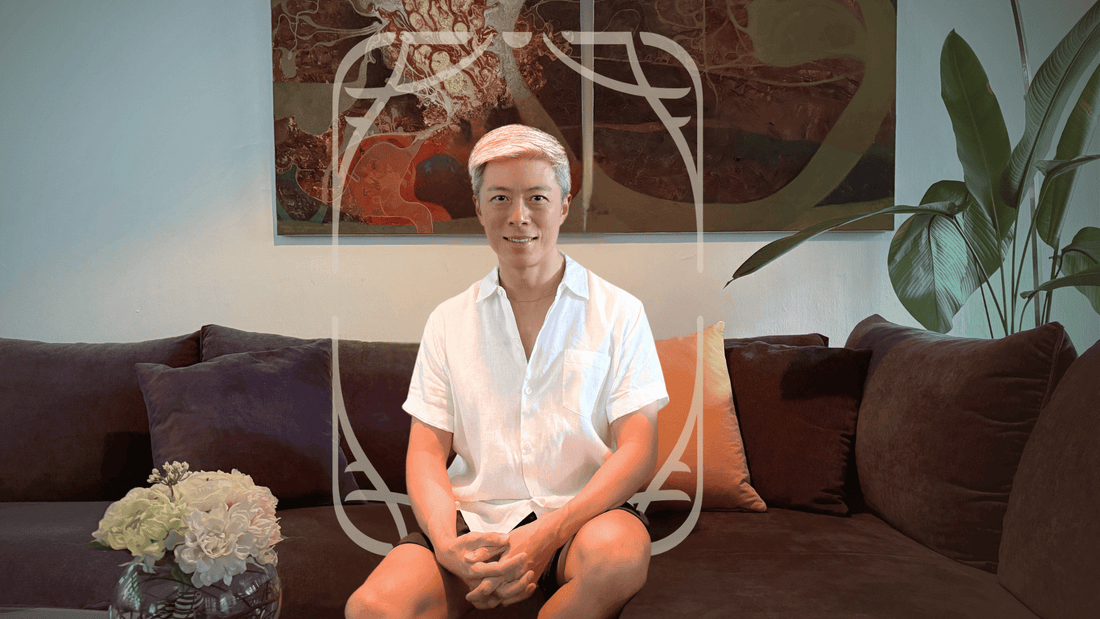 A man sitting on a sofa in a living room.