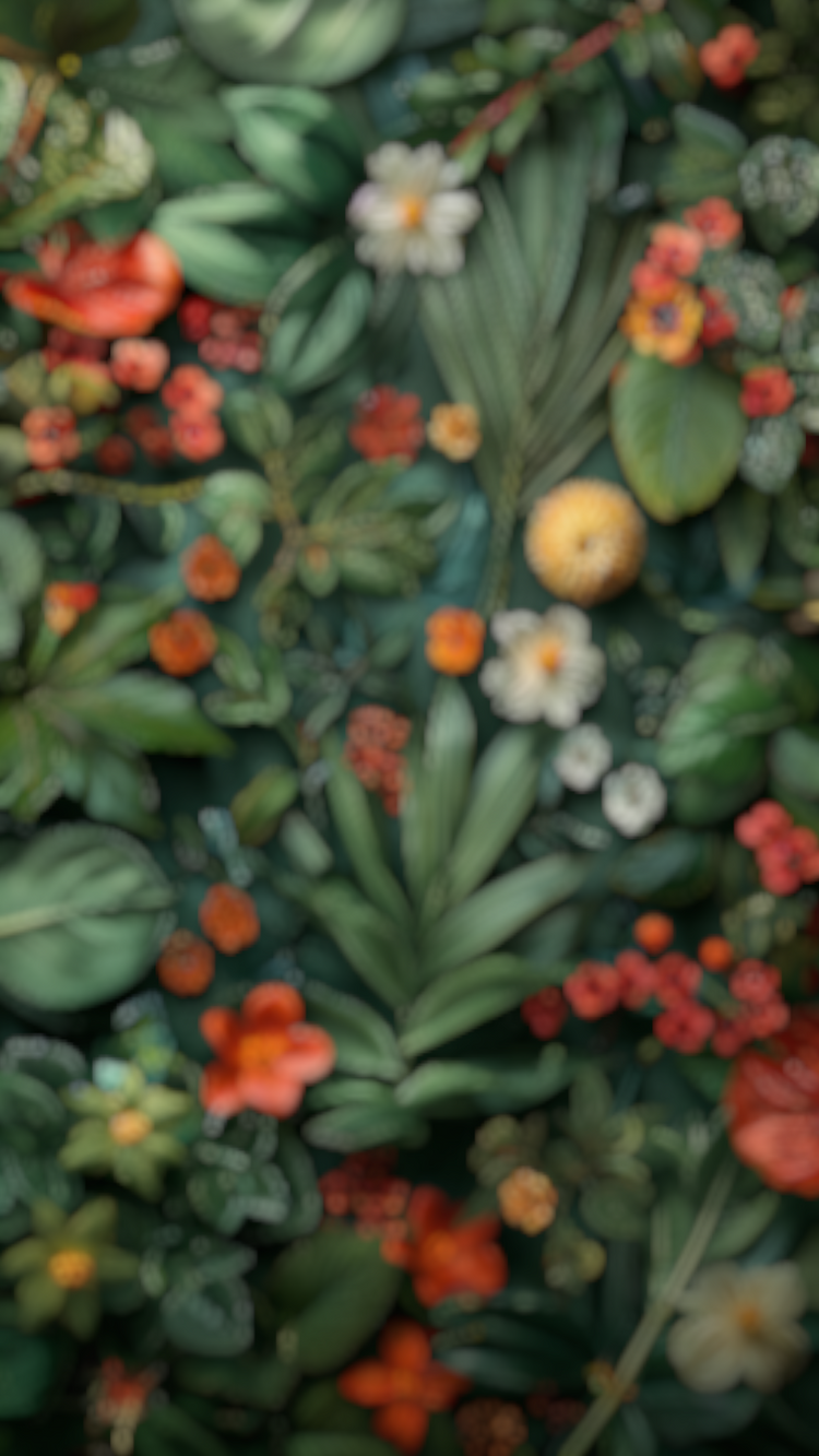 A blurred background of tropical leaves and flowers in green and red tones.