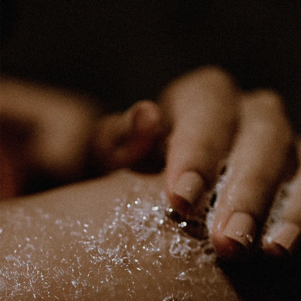 Close-up of a hand applying a cleanser to their skin.